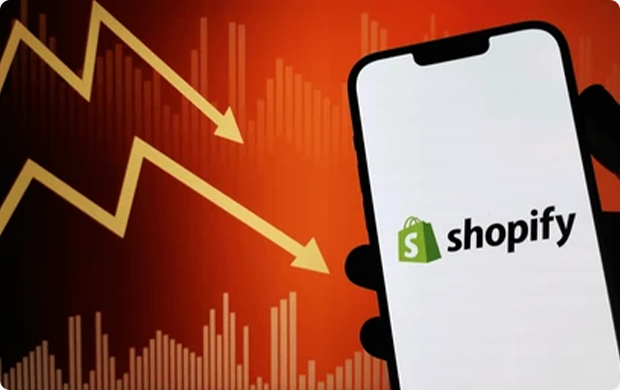 shopify logo on phone with stock market decline background shopify-logo-on-phone-with-stock-market
