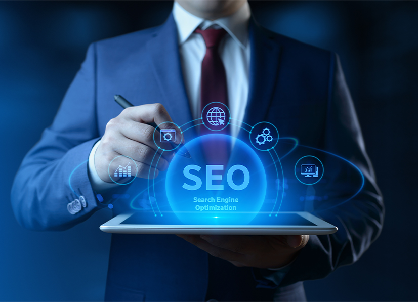 A Person In A Suit Holding A Tablet With A Glowing SEO Icon.